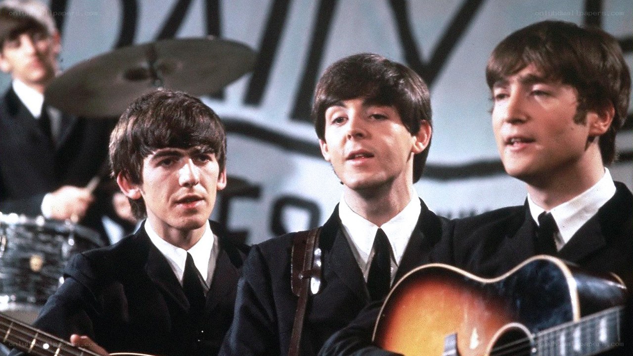 The Beatles performing on stage