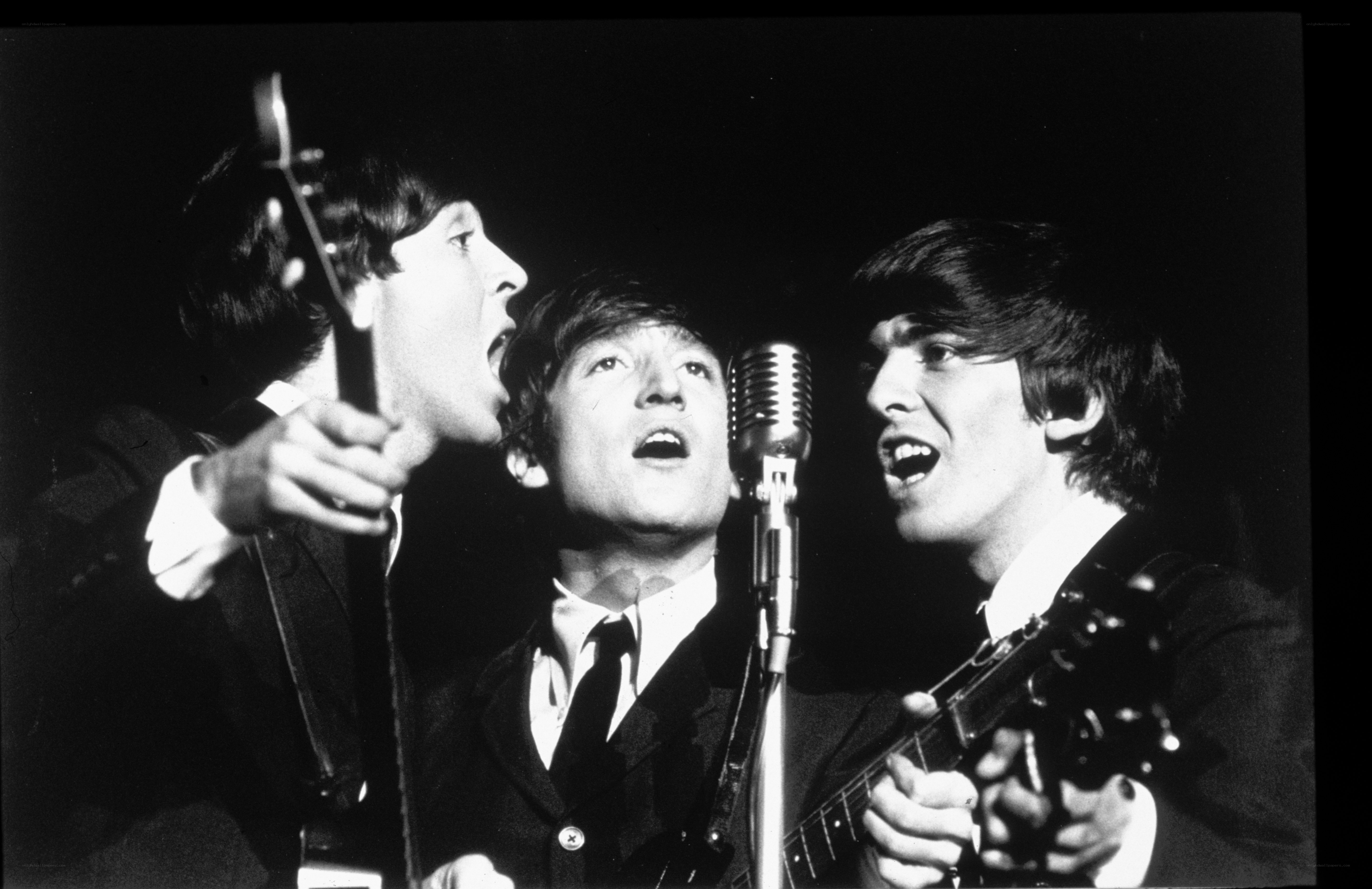 The Beatles performing on stage