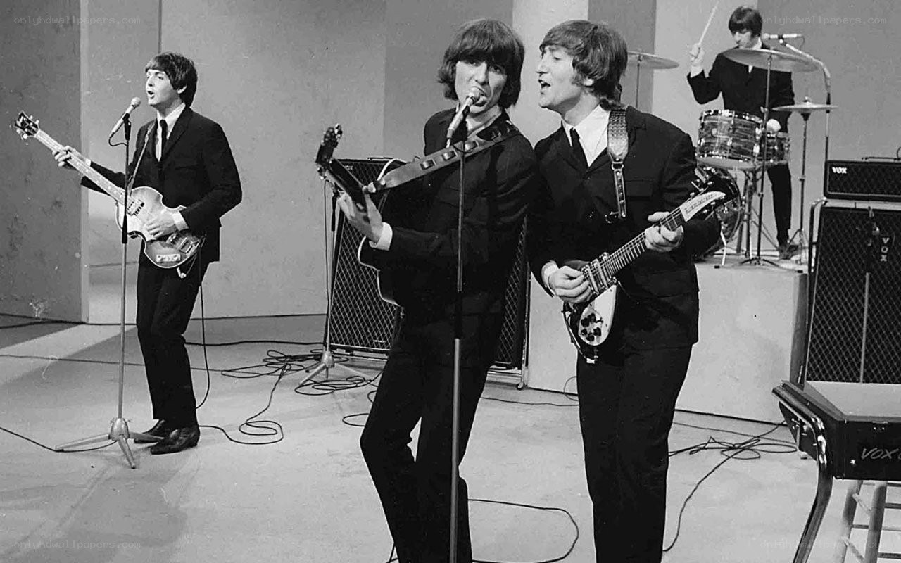 The Beatles performing on stage
