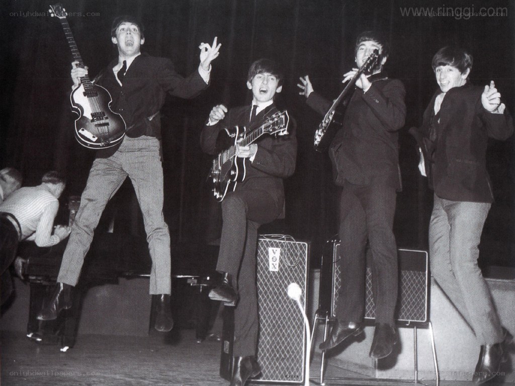 The Beatles performing on stage