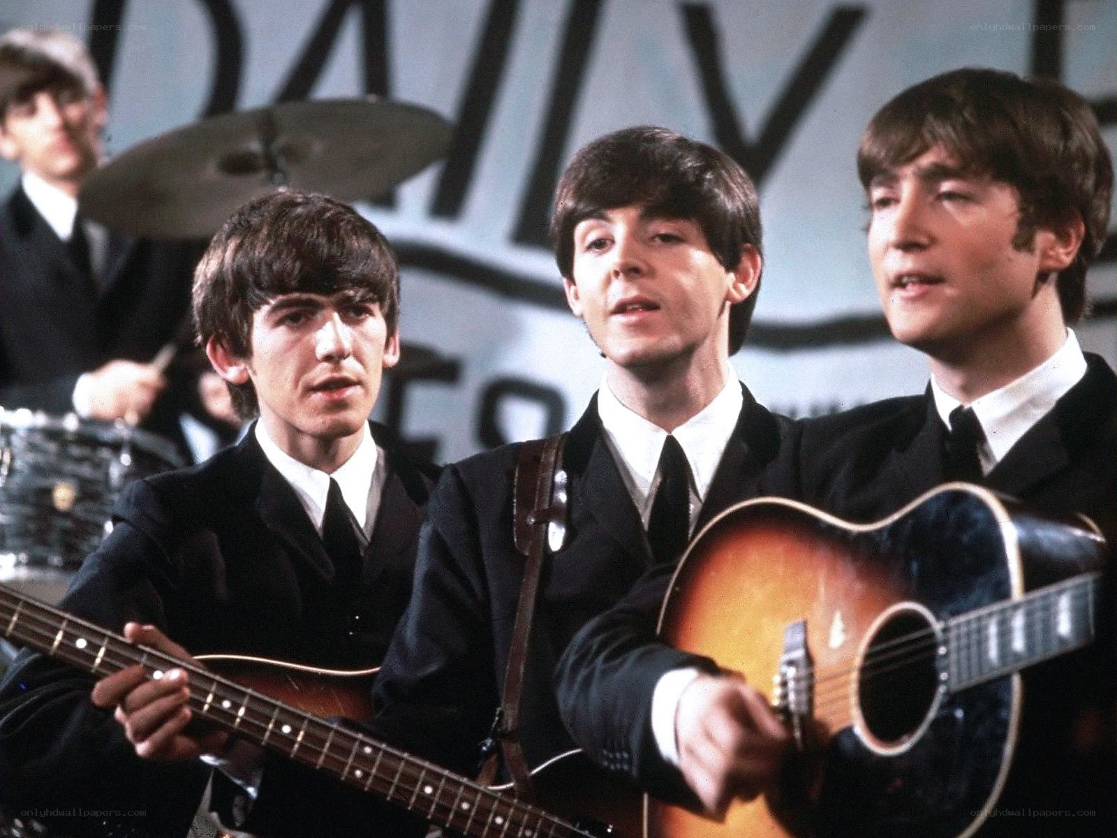 The Beatles performing on stage