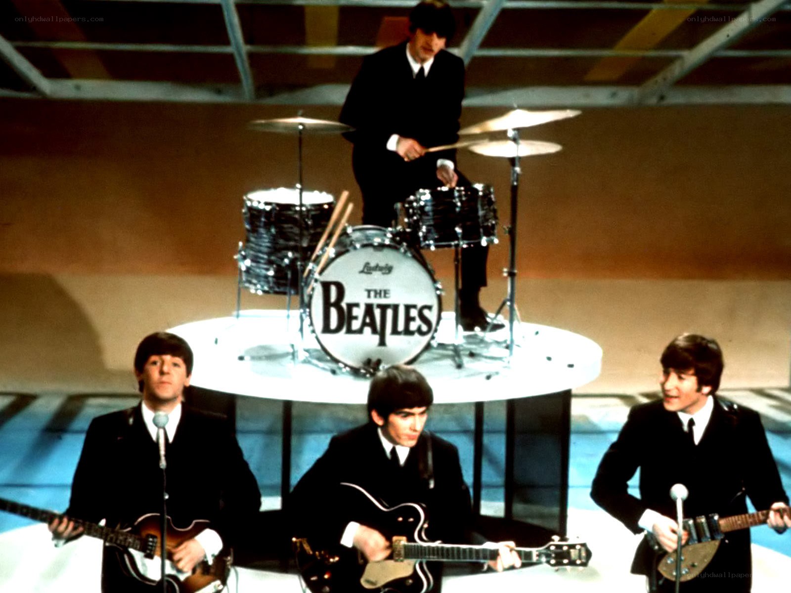 The Beatles performing on stage