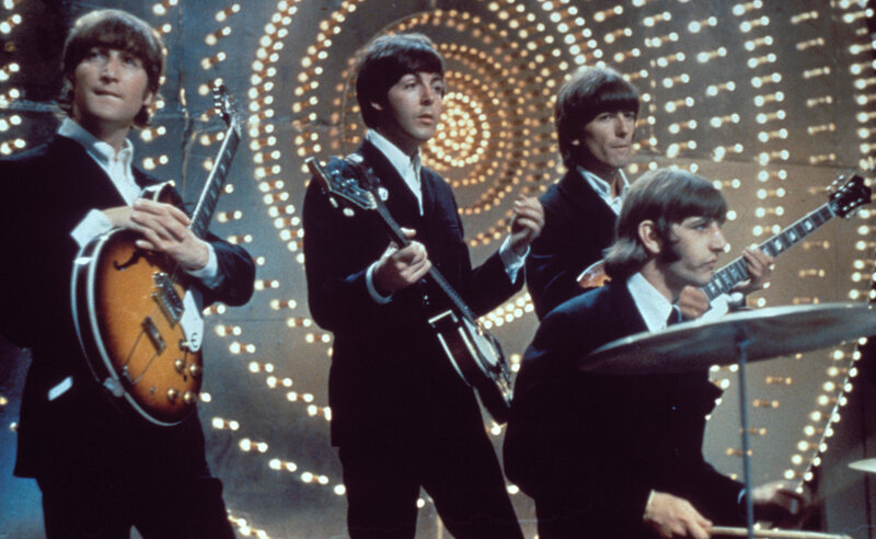 The Beatles performing on stage