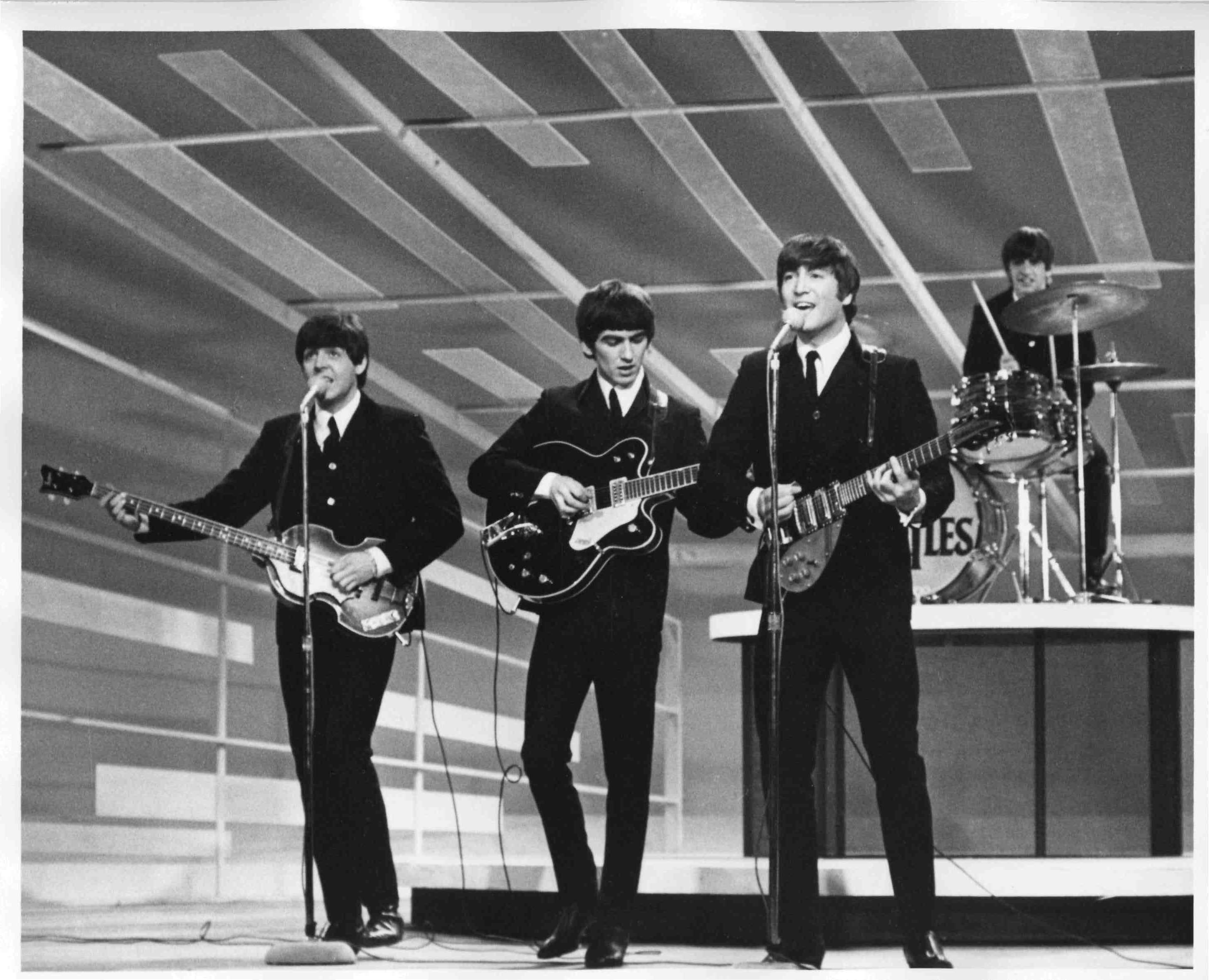 The Beatles performing on stage