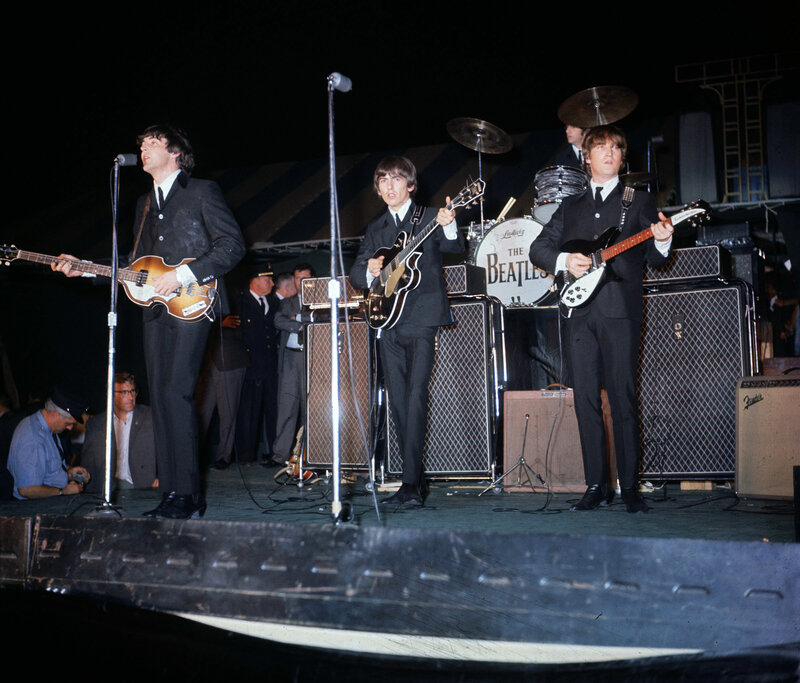 The Beatles performing on stage