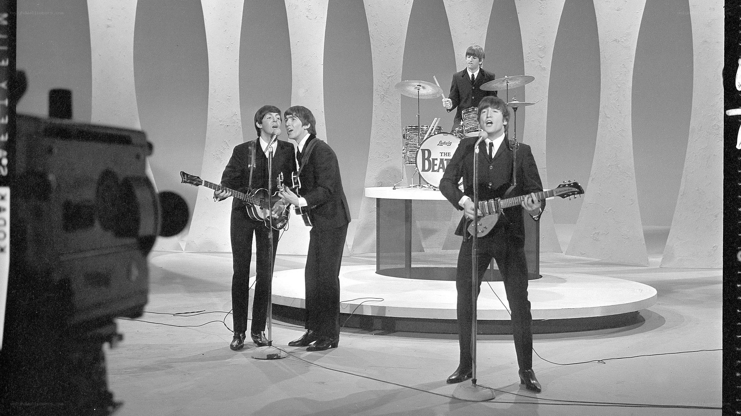 The Beatles performing on stage
