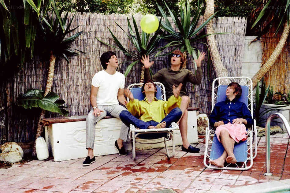 The Beatles playing with a balloon