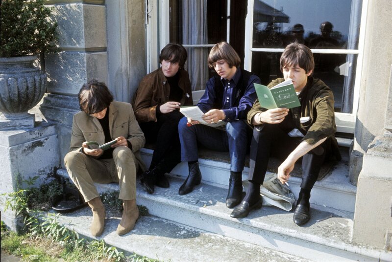 The Beatles reading on steps