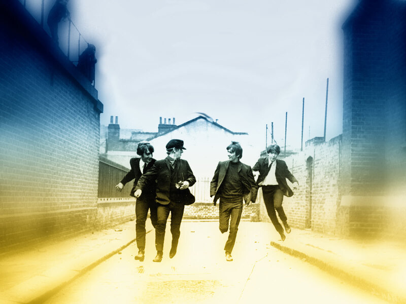 The Beatles running down an alley