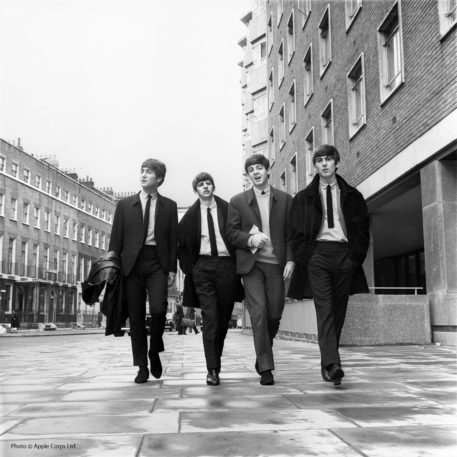 The Beatles walking down a street