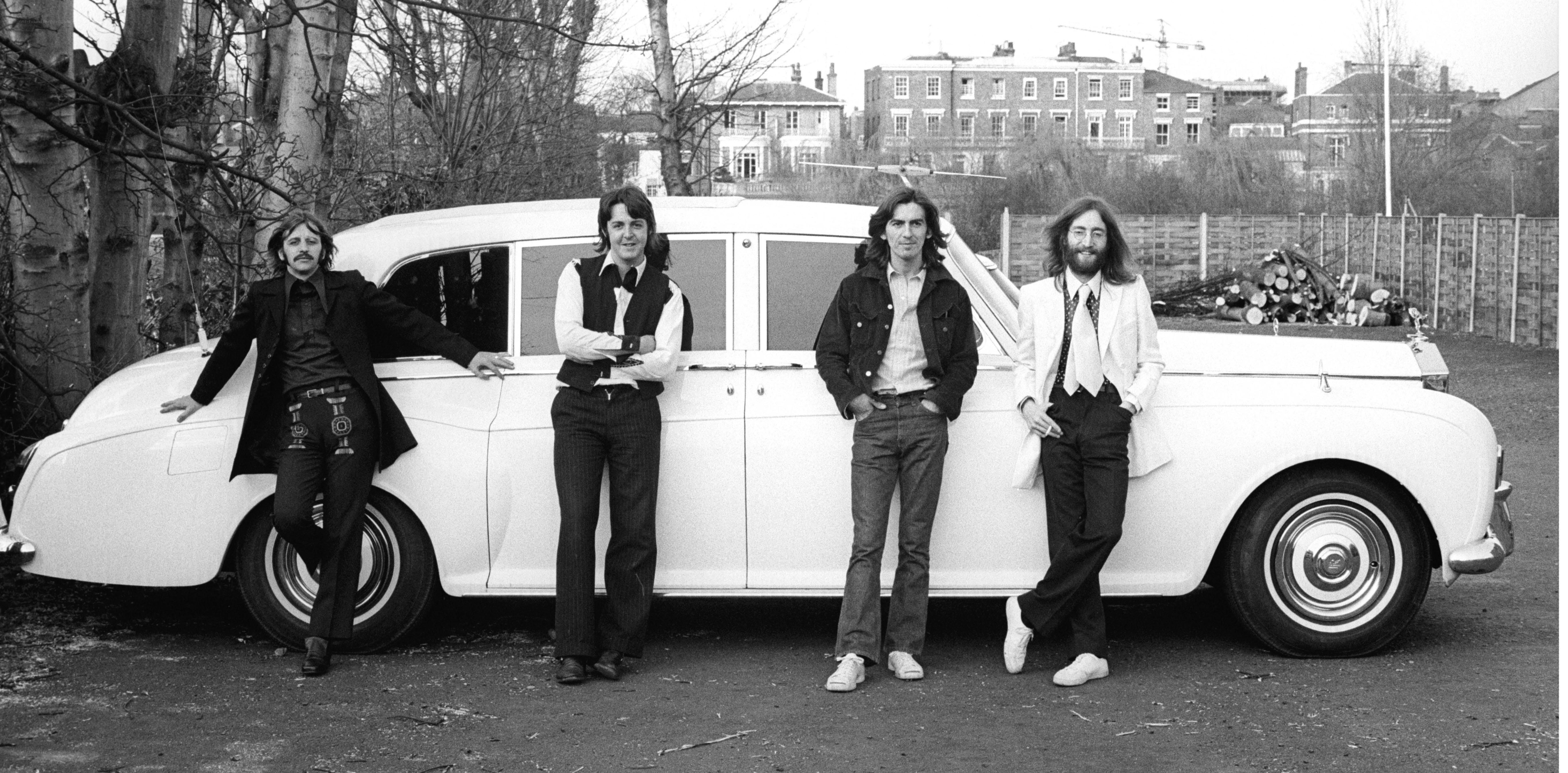 The Beatles with a white car
