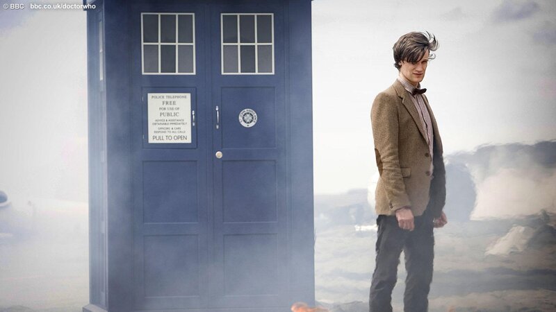 The Doctor stands beside the TARDIS