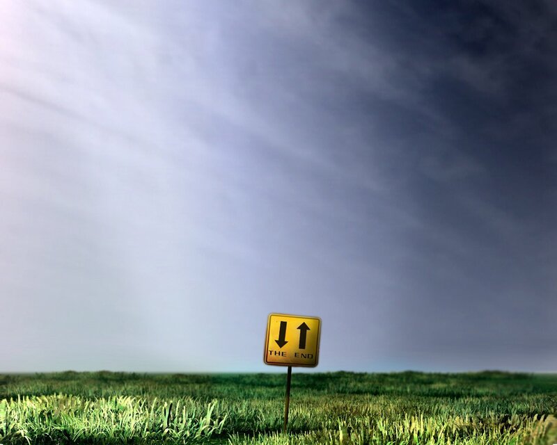 The End road sign in a field