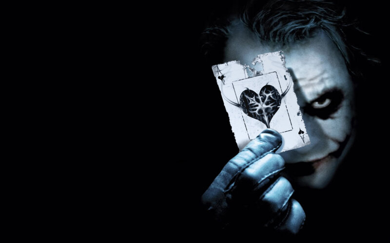 The Joker holding a card