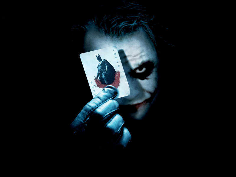 The Joker holding a card