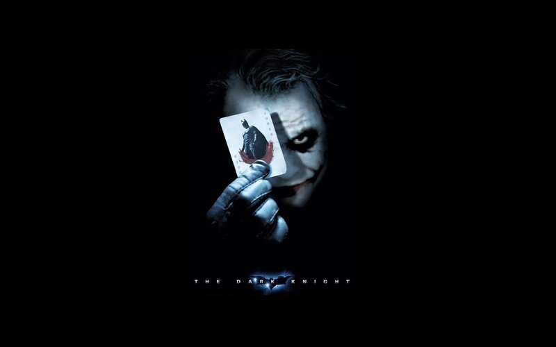 The Joker holding a card