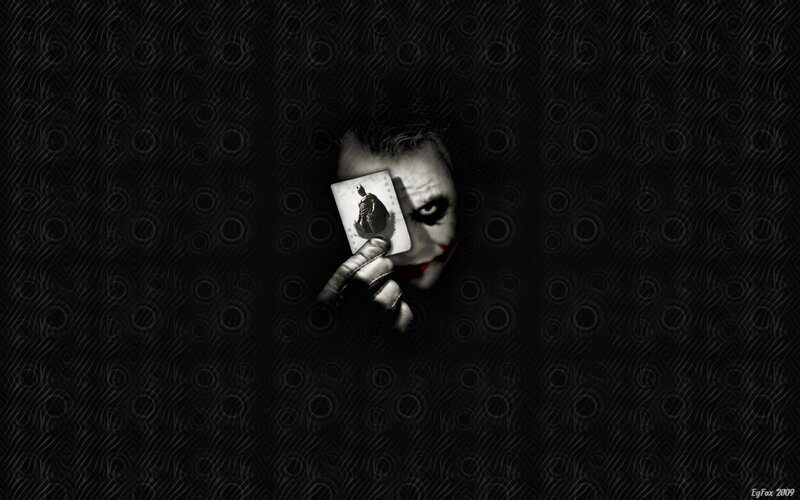 The Joker holding a card