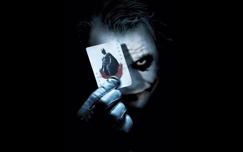 The Joker holding a card
