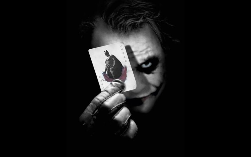 The Joker holding a card