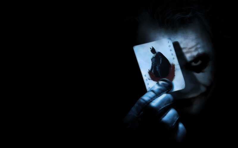 The Joker holding a card