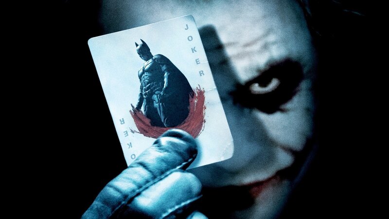 The Joker Holding a Card — Black, Dark, Dramatic, Night, Photograph