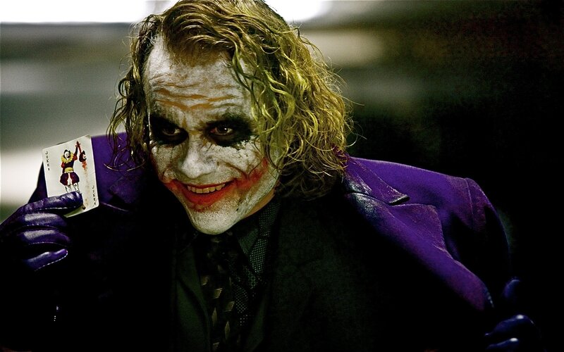 The Joker holding a joker card