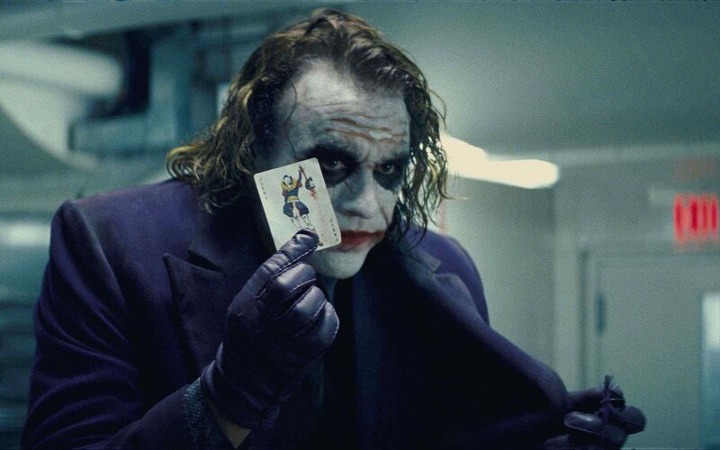 The Joker holding a playing card