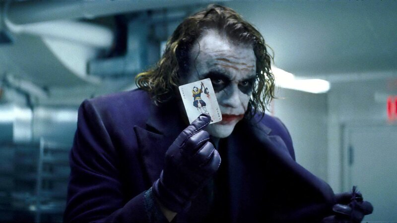 The Joker holding a playing card