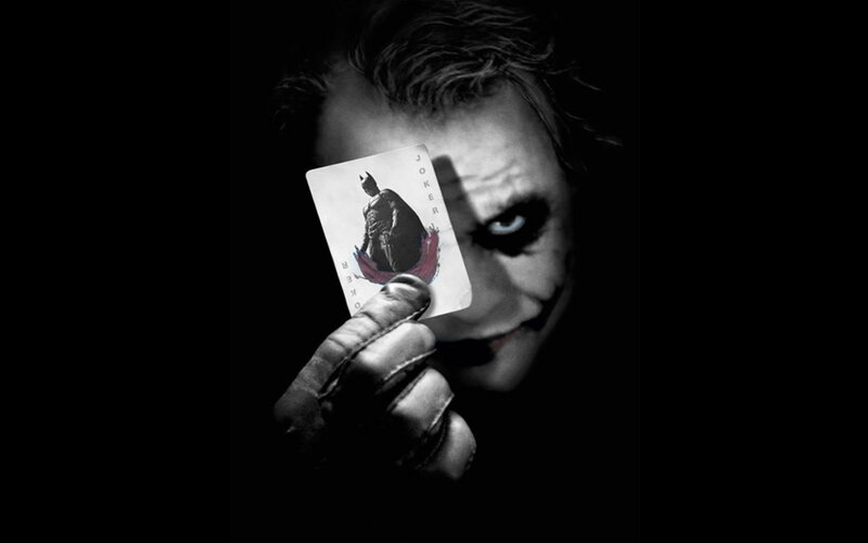 The Joker holding a playing card