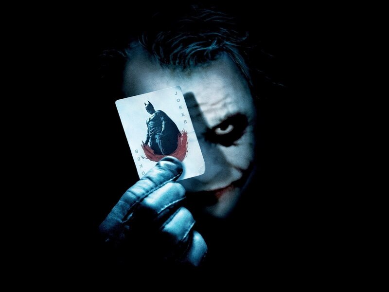 The Joker holding a playing card