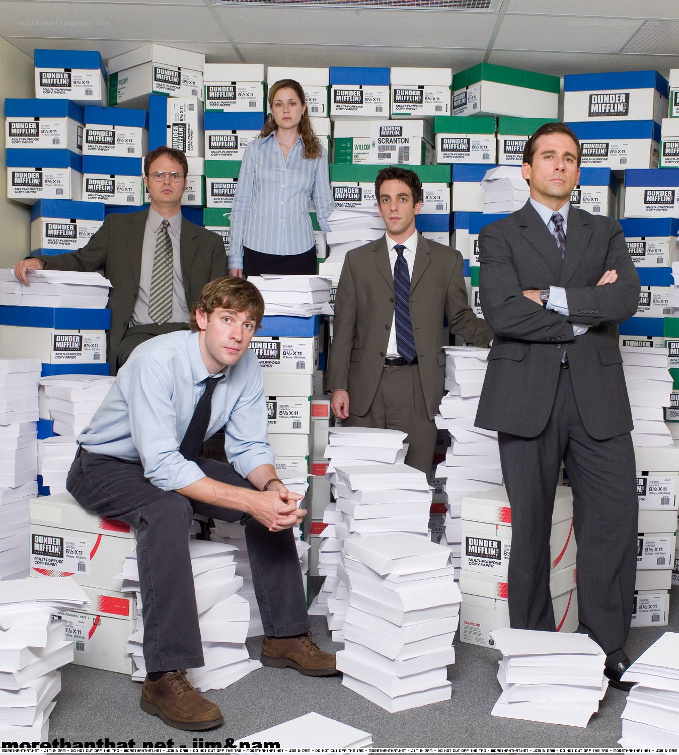 The Office cast surrounded by paper