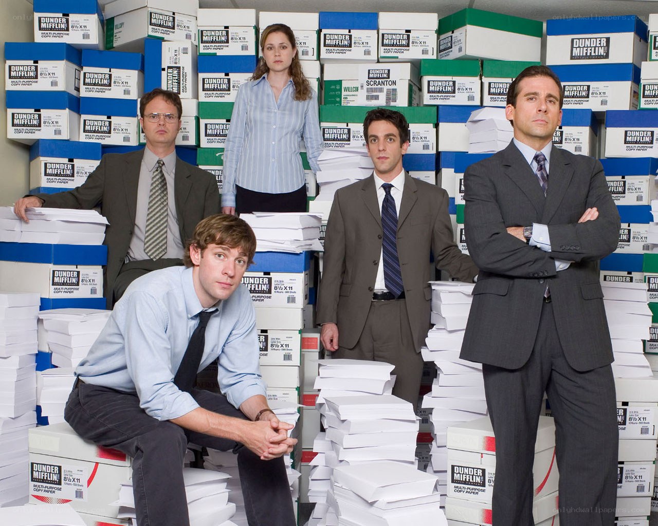 The Office cast surrounded by paper