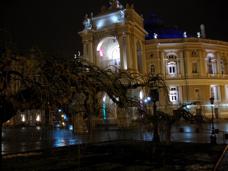 Theatre at night with wet pavement