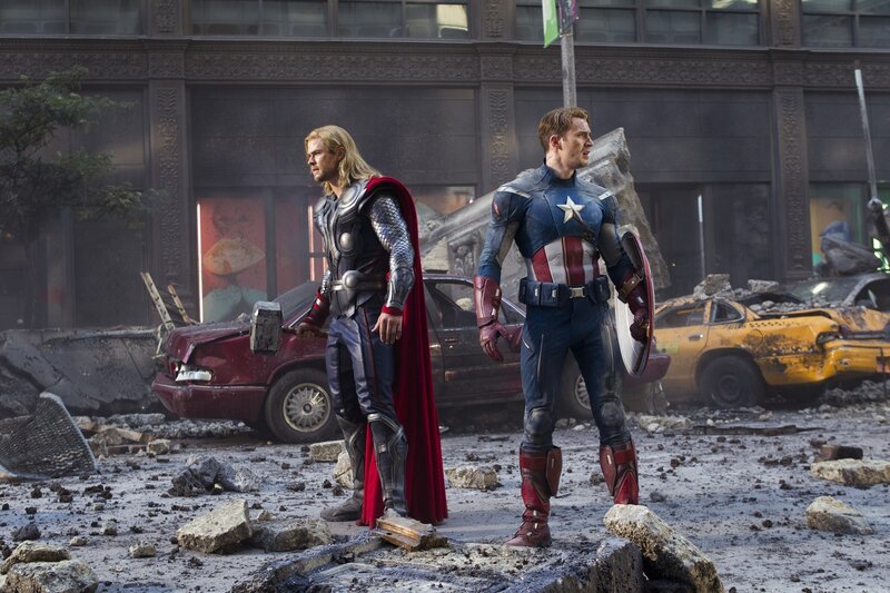 Thor and Captain America stand amidst rubble