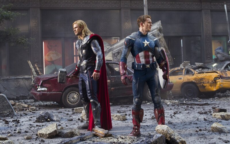 Thor and Captain America stand amidst rubble
