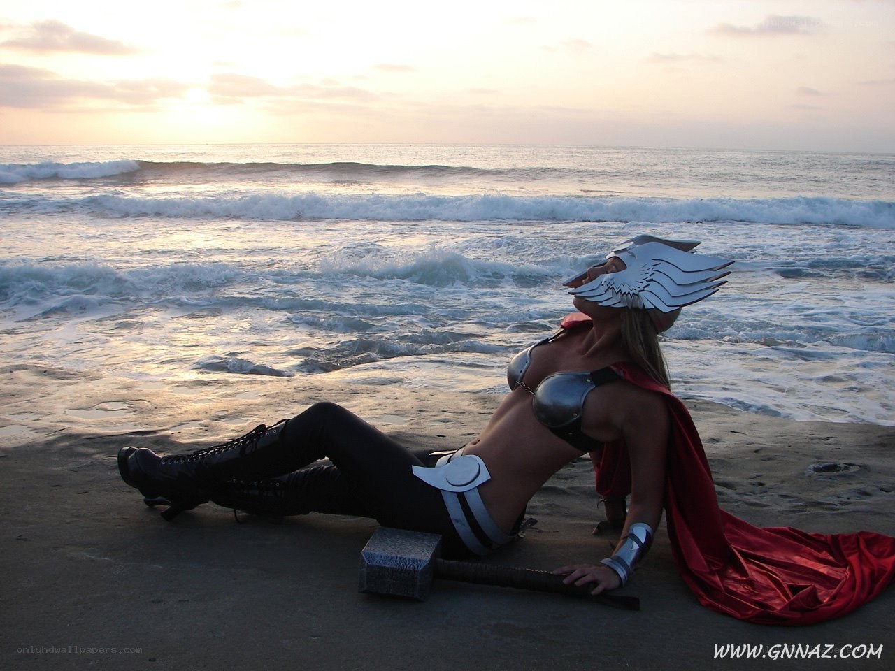 Thor cosplayer on beach at sunset