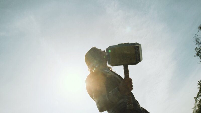 Thor holding Mjolnir in sunlight