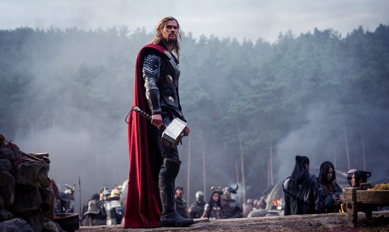 Thor stands with Mjolnir in a smoky field
