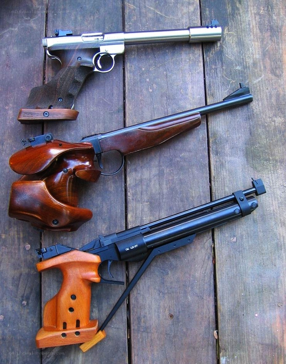 Three air guns on wood
