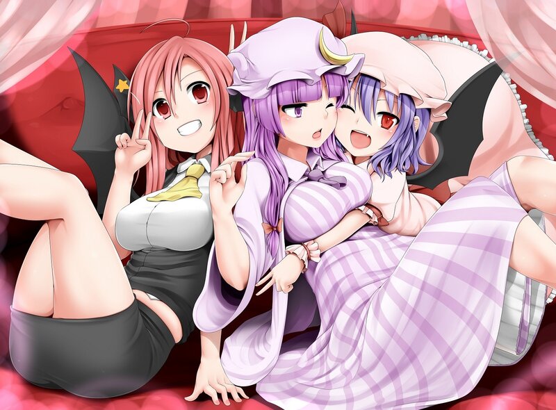 Three anime girls on a bed