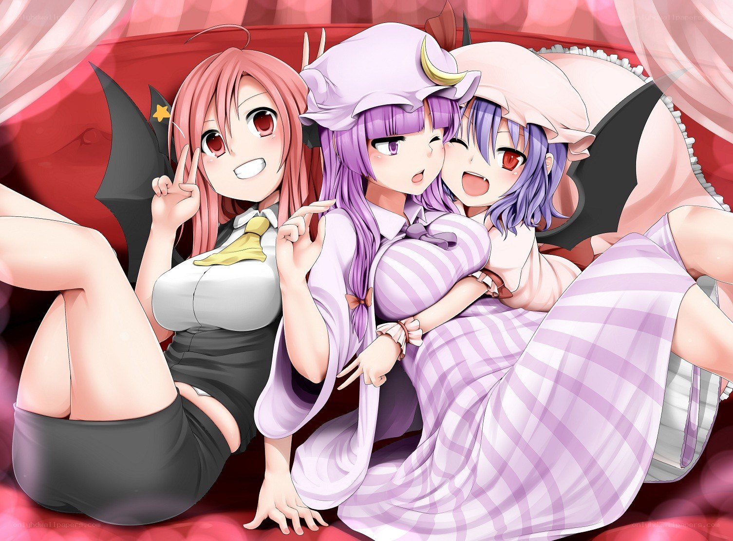 Three anime girls on a bed