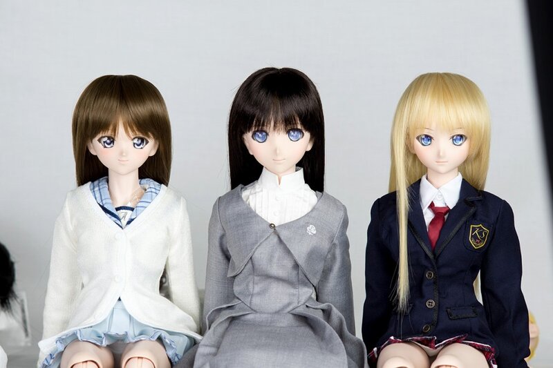 Three anime-style dolls in school uniforms