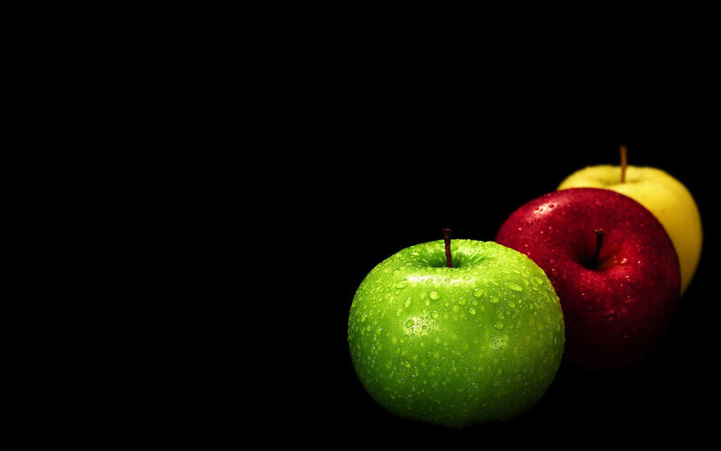 three apples on black background