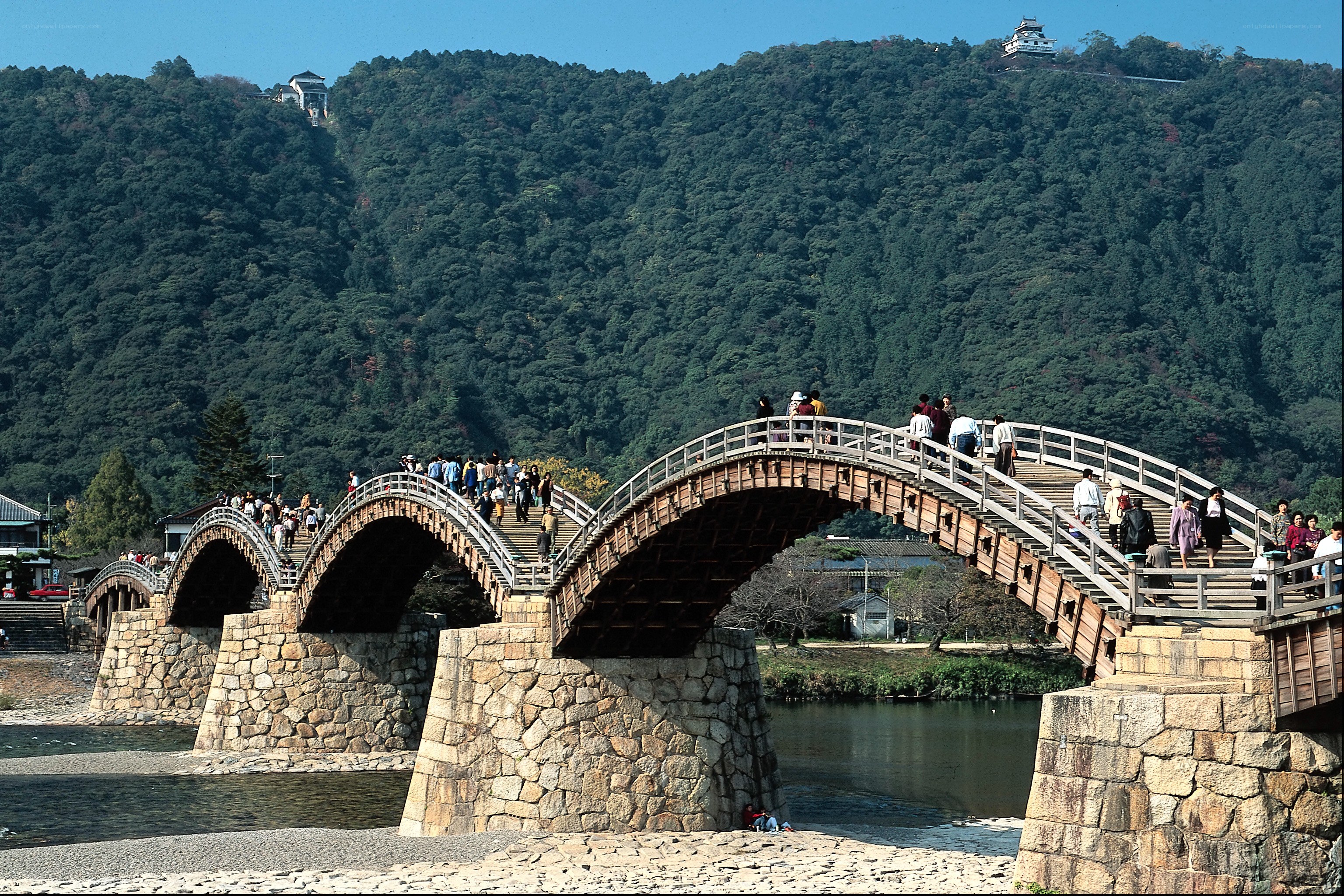 Three-arched wooden bridge over river