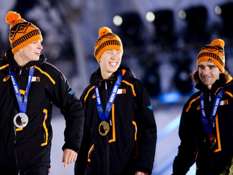 Three Athletes on Podium — Black, Celebratory, Night