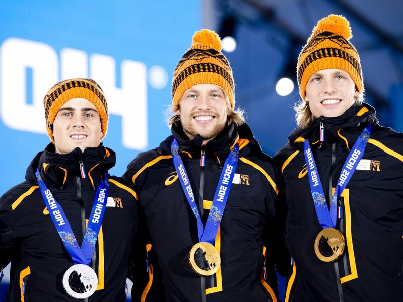 Three Athletes on Podium — Black, Celebratory