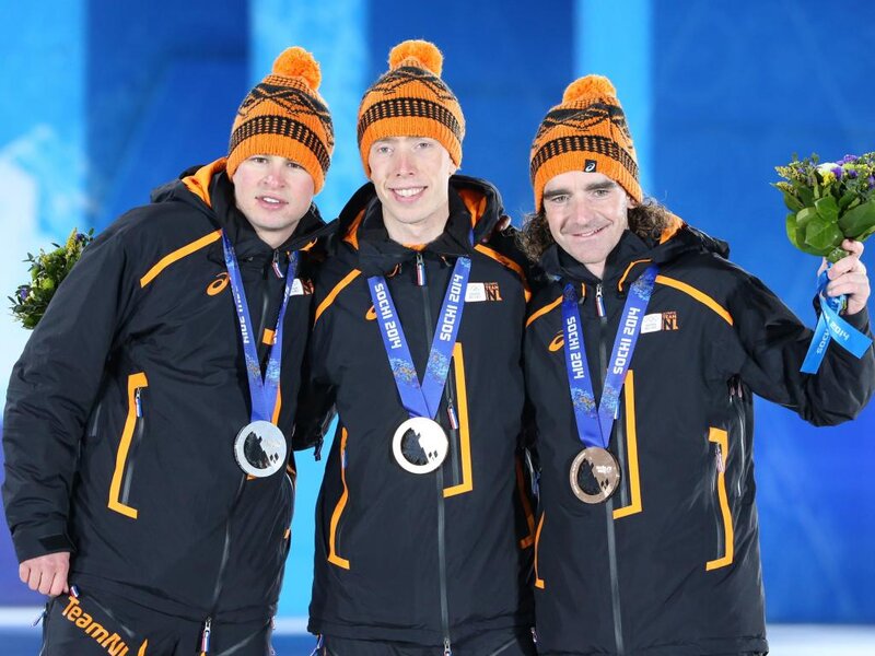 Three Athletes on Podium — Black, Celebratory, Winter