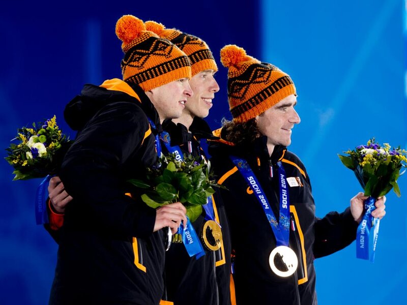 Three Athletes on Podium — Blue, Celebratory
