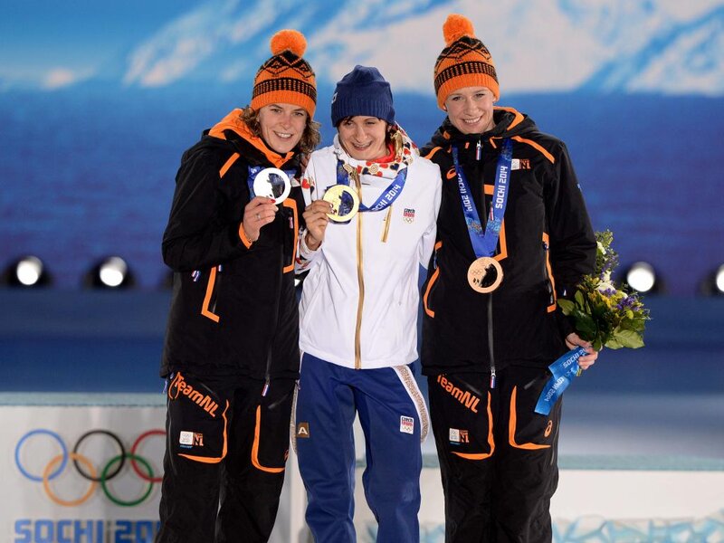 Three Athletes on Podium — Blue, Celebratory, Winter