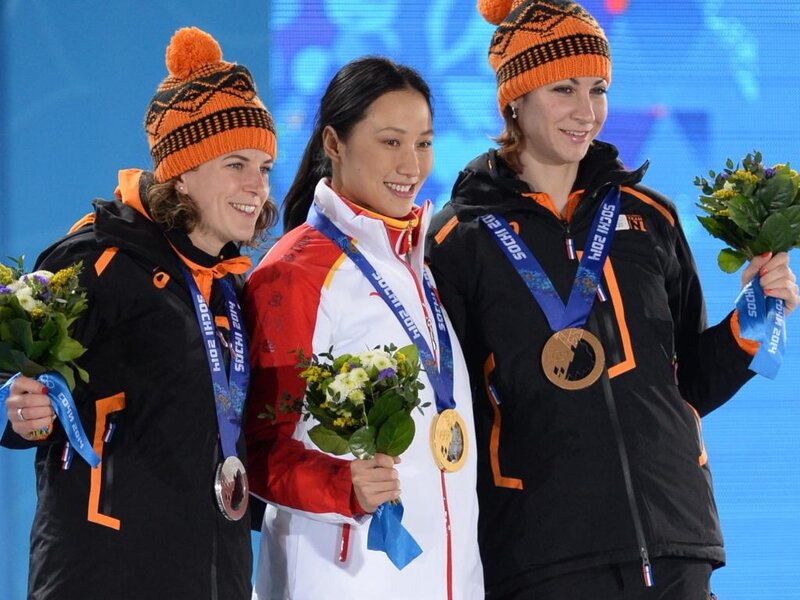 Three Athletes on Podium — Blue